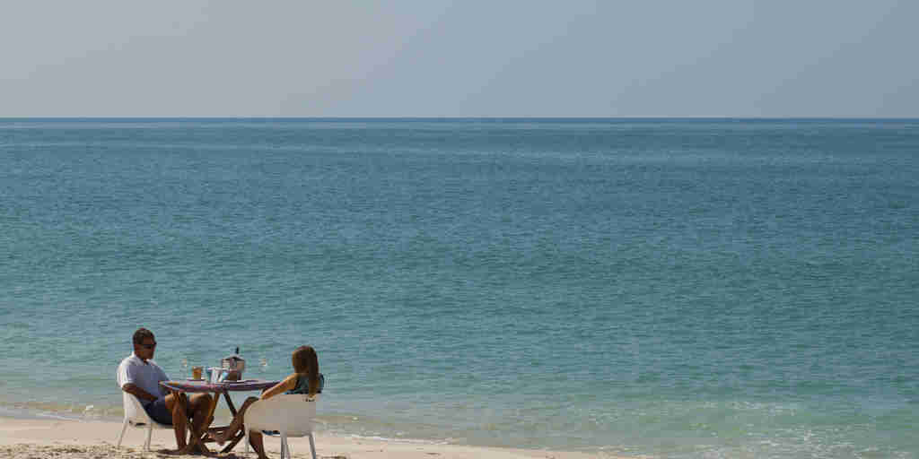 Azura Benguerra beach picnic couple with view on ocean