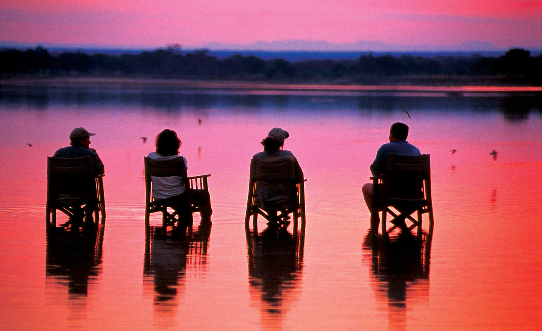 pink sunset, sundowners in zambia, africa safaris