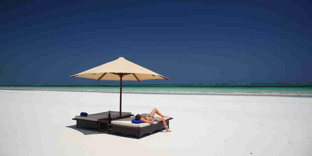 sunbathing, diani beach, kenya safari holidays
