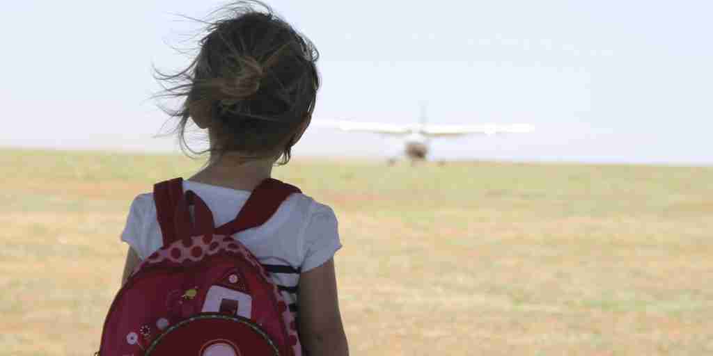 Family experience young girl watching plane arrive