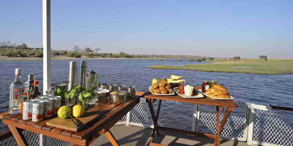 &Beyond Chobe Under Canvas boating food alcohol
