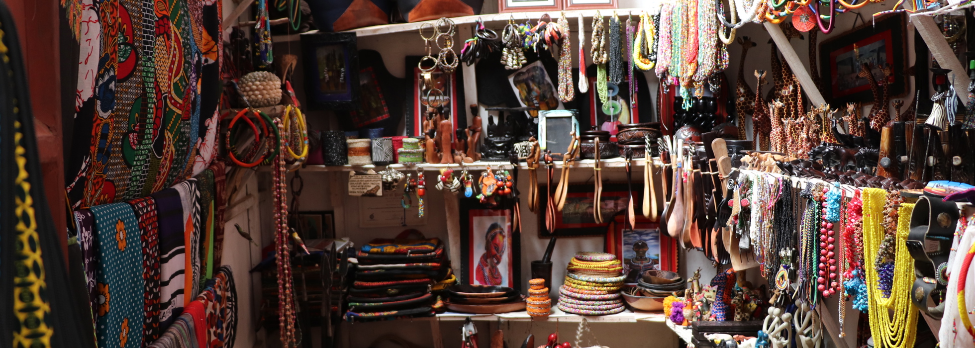 A vendors area selling beaded jewlery and some wooden and ebony carvings
