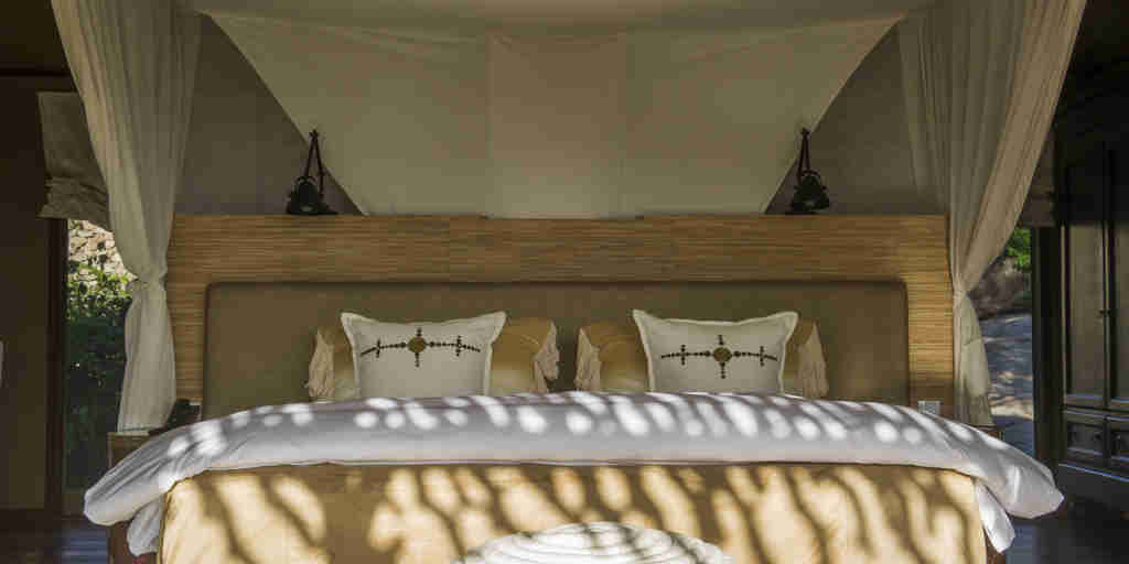 bed bedroom mwiba lodge tanzania yellow zebra safaris