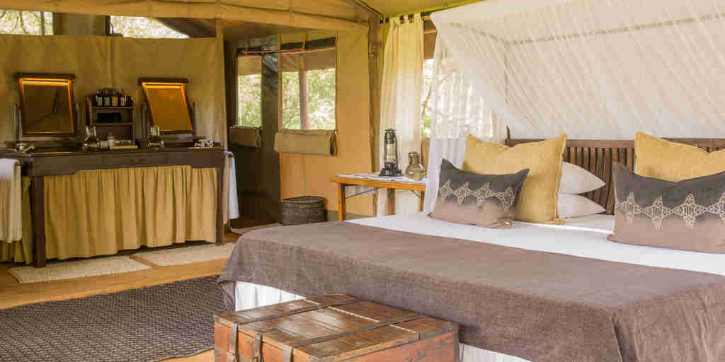 mwiba tented camp tanzania vintage bedroom yellow zebra safaris