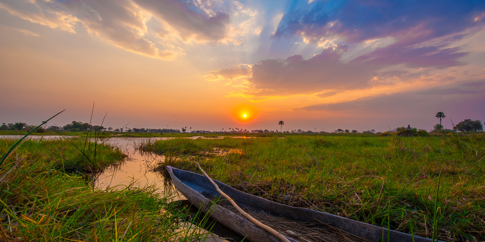 delta camp mokoro sunset botswana yellow zebra safaris
