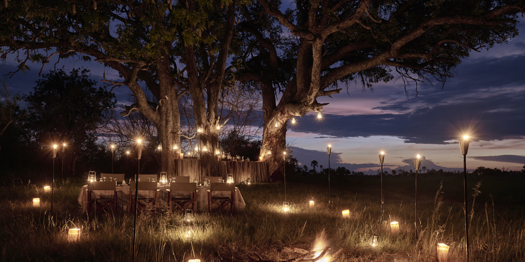 sanctuary baines camp dining night botswana yellow zebra safaris