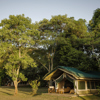 governors camp tent exterior kenya yellow zebra safaris