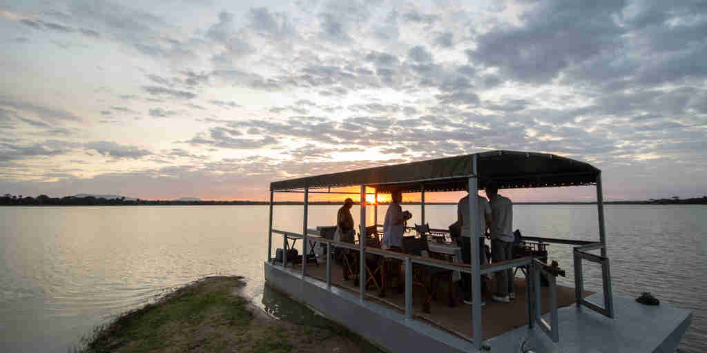 boating sundowners, siwandu camp, nyerere national park, tanzania