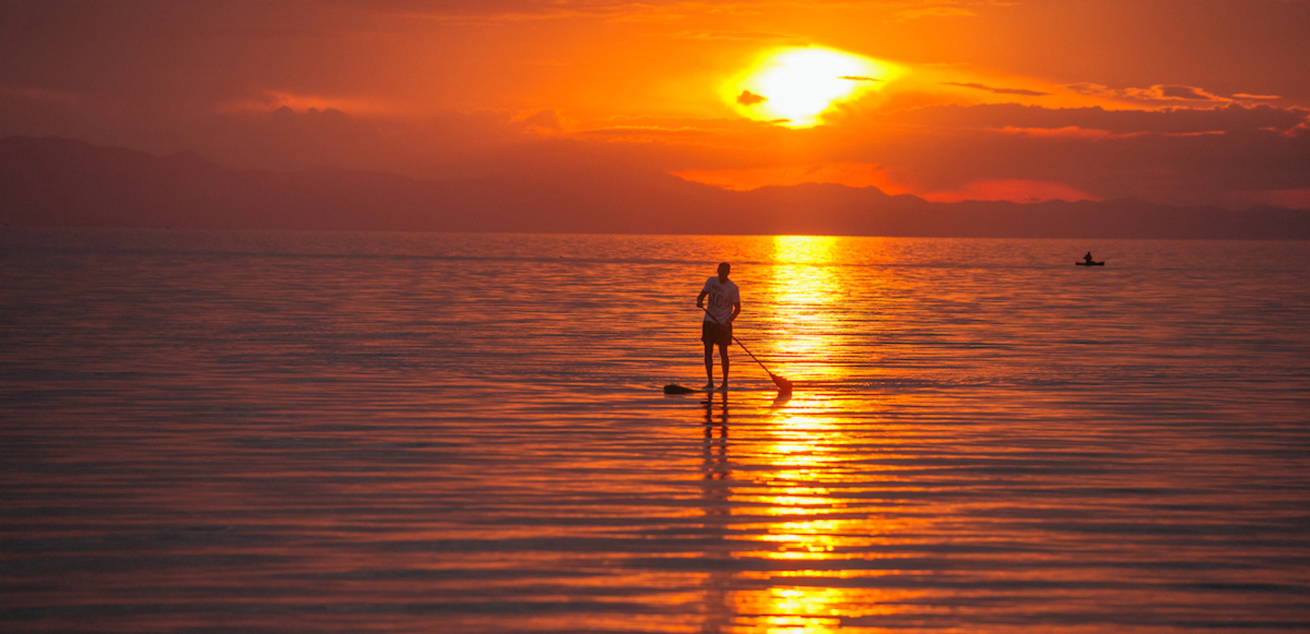 sunset paddle boarding, pumulani lodge, malawi