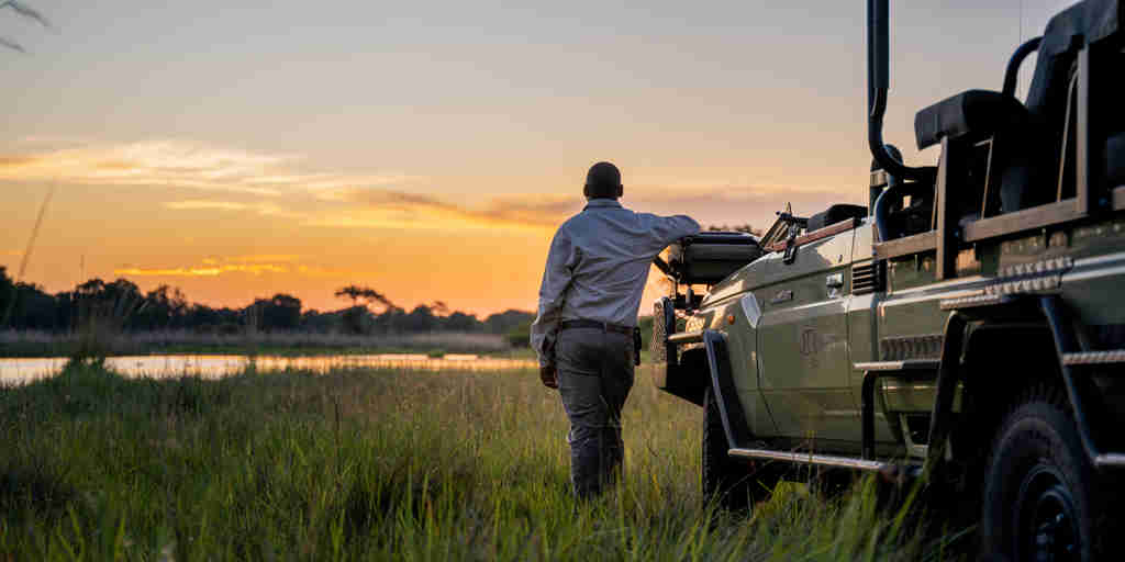 driver and vehicle, 4 rivers, okavango delta, botswana