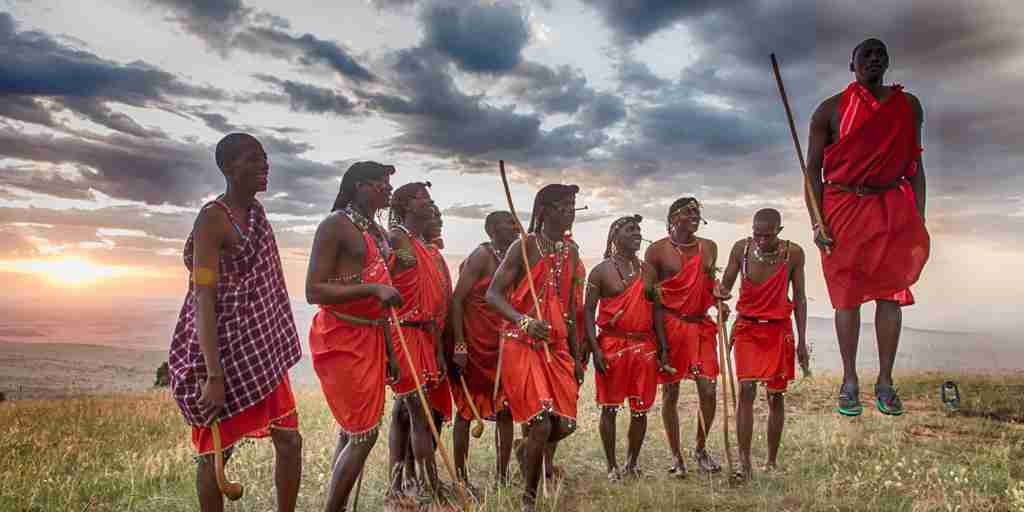 Massai warriors jumping with sunset