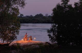 Private riverside dinner at dusk, Mosi-oa-Tunya National Park, Zambia, Yellow Zebra Safaris