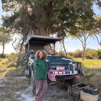 Eleanor stands by a safari vehicle, Okavango Delta, Botswana, Yellow Zebra Safaris