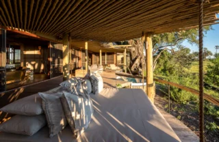 Exterior decking seating looking out onto the reserve, Mombo, Moremi Game Reserve, Botswana - Yellow Zebra Safari