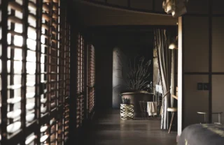 Hallway view down to a freestanding steel bath, Mombo, Moremi Game Reserve, Botswana - Yellow Zebra Safari