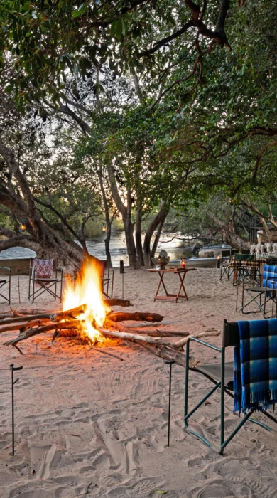 ichingo chobe river lodge camp fire botswana yellow zebra safaris