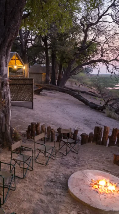camp linyanti botswana camp fire yellow zebra safaris