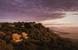 Aerial view of the lodge amidst thick forest at sunset, Angama Mara, Masaai Mara, Kenya - Yellow Zebra Safari