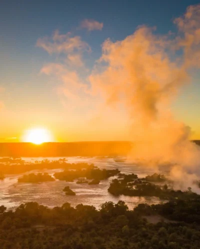 Sunset and thick clouds partly obscure Victoria Falls, Zimbabwe - Yellow Zebra Safaris