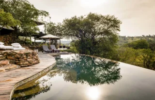 The sun is reflecting off a plunge pool, Singita Faru Faru Lodge, Tanzania - Yellow Zebra Safari