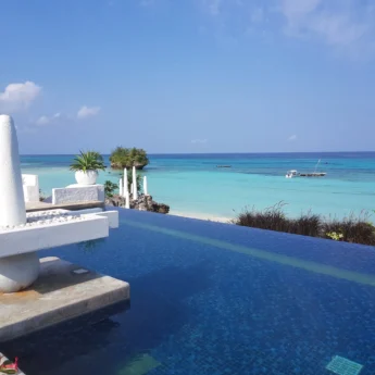 A blue pool overlooks the turquoise ocean, Constance Aiyana Pemba, Zanzibar - Yellow Zebra Safari