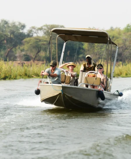 A boat motoring down the Zambezi, Lower Zambezi National Park, Zambia - Yellow Zebra Safaris