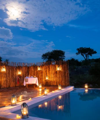 Lanterns light up an outdoor pool, Lemala, Tanzania - Yellow Zebra Safari