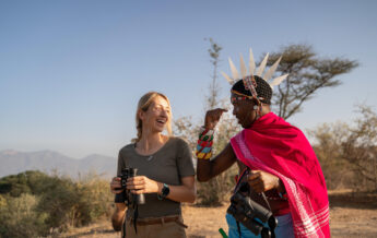 A man in tradition Samburu dress talks to a guest, Sarara Treehouses, Namunyak Conservancy, Kenya - Yellow Zebra Safari