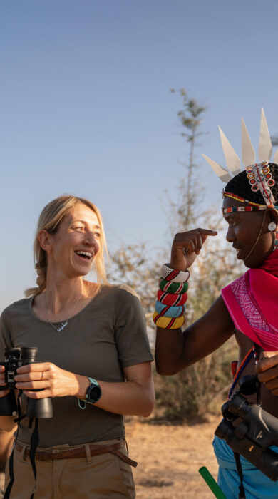 A man in tradition Samburu dress talks to a guest, Sarara Treehouses, Namunyak Conservancy, Kenya - Yellow Zebra Safari