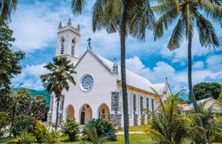 A palm fringed shot of a white church, Beau Vallon, Seychelles - Yellow Zebra Safaris