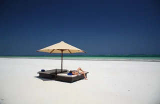 sunbathing, diani beach, kenya safari holidays