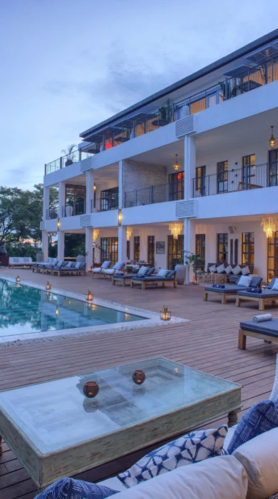 Exterior view of the pool, loungers and balconies at sunset at Latitude 0 Degrees, Kampala, Uganda - Yellow Zebra Safaris